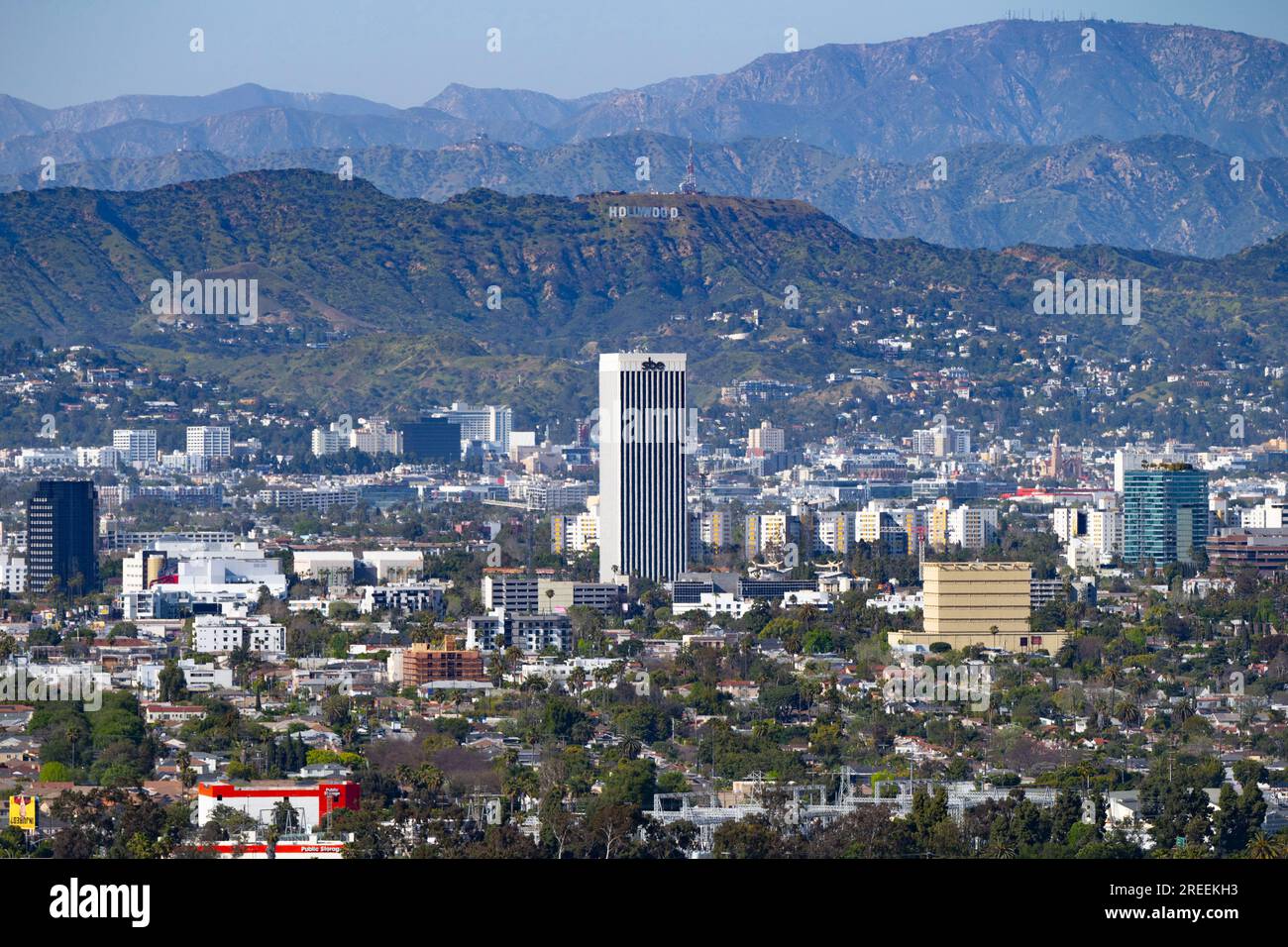 Culver City, California, USA. 19th Apr, 2023. The SBE Building, also known as 5900 Wilshire Avenue, in Miracle Mile with the Hollywood Sign in the background seen from Baldwin Hills Scenic Overlook.SBE Entertainment Group is a nightlife and hospitality company led by CEO Sam Nazarian. (Credit Image: © Taidgh Barron/ZUMA Press Wire) EDITORIAL USAGE ONLY! Not for Commercial USAGE! Stock Photo