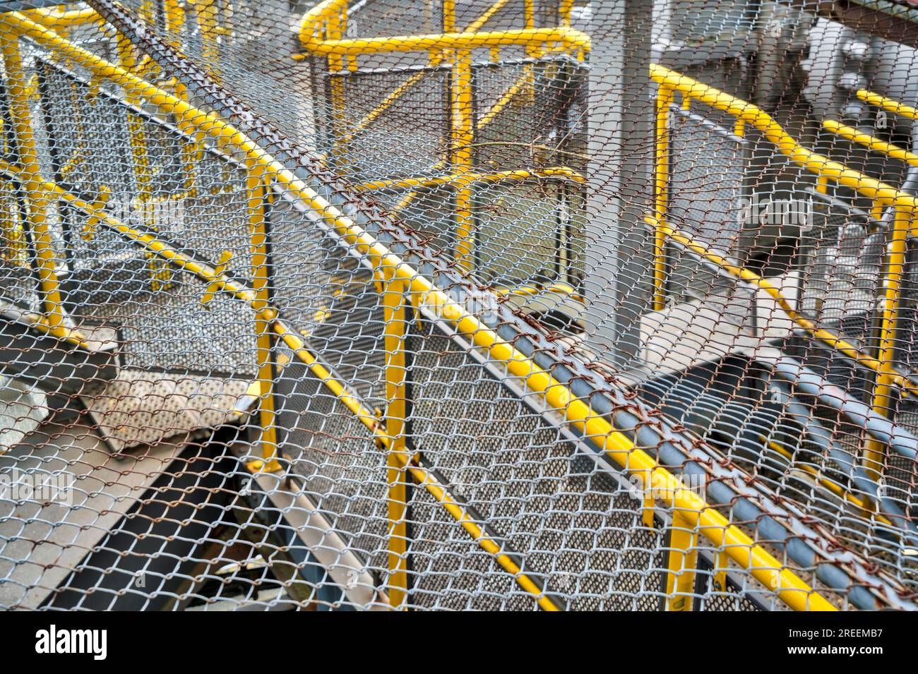 Old rusty fences over yellow railings Stock Photo - Alamy
