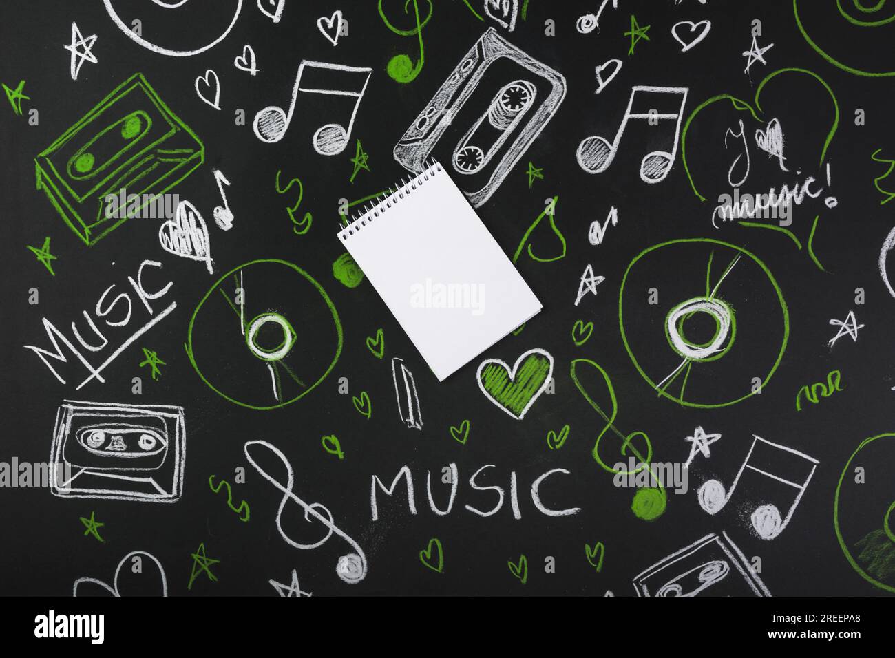 Spiral blank notepad blackboard with drawn musical notes cassette tapes ...