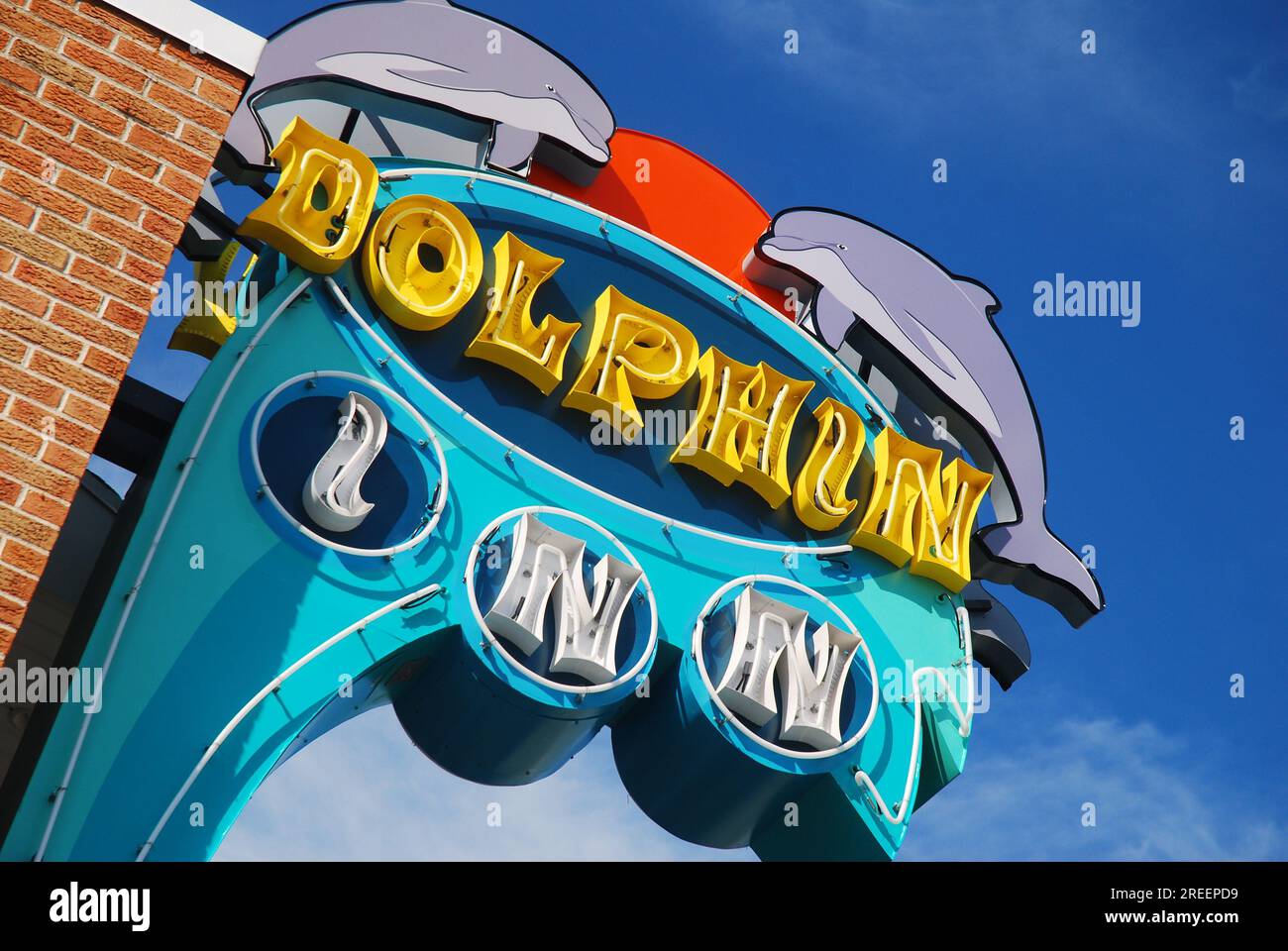 A large sign of the Dolphin Inn in Wildwood, New Jersey showcases the whimsy and fun feeling of a 1950s style doo wop architecture of the motels Stock Photo