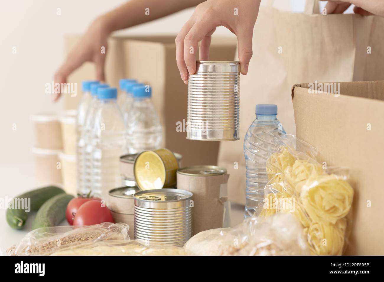 Volunteers putting canned food donation box. Resolution and high