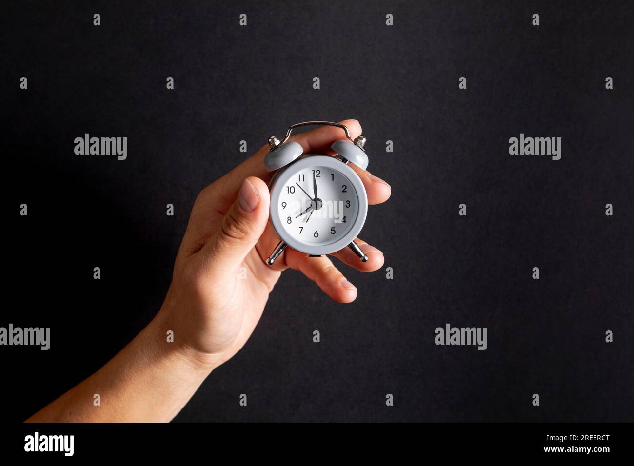 Hand holding vintage little clock Stock Photo Alamy