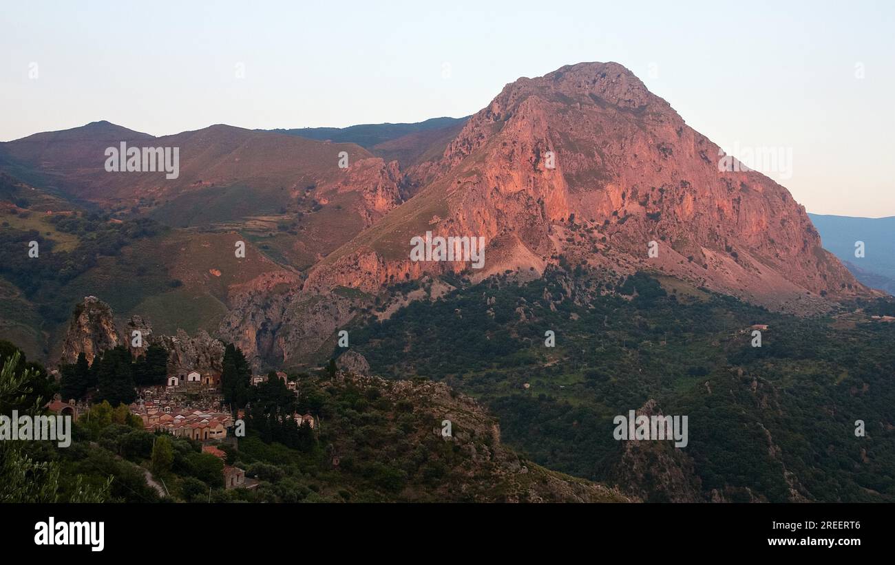 Red evening light, Mountain, Cemetery, Militello Rosmarino, Village, Nebrodi National Park, Sicily, Italy Stock Photo