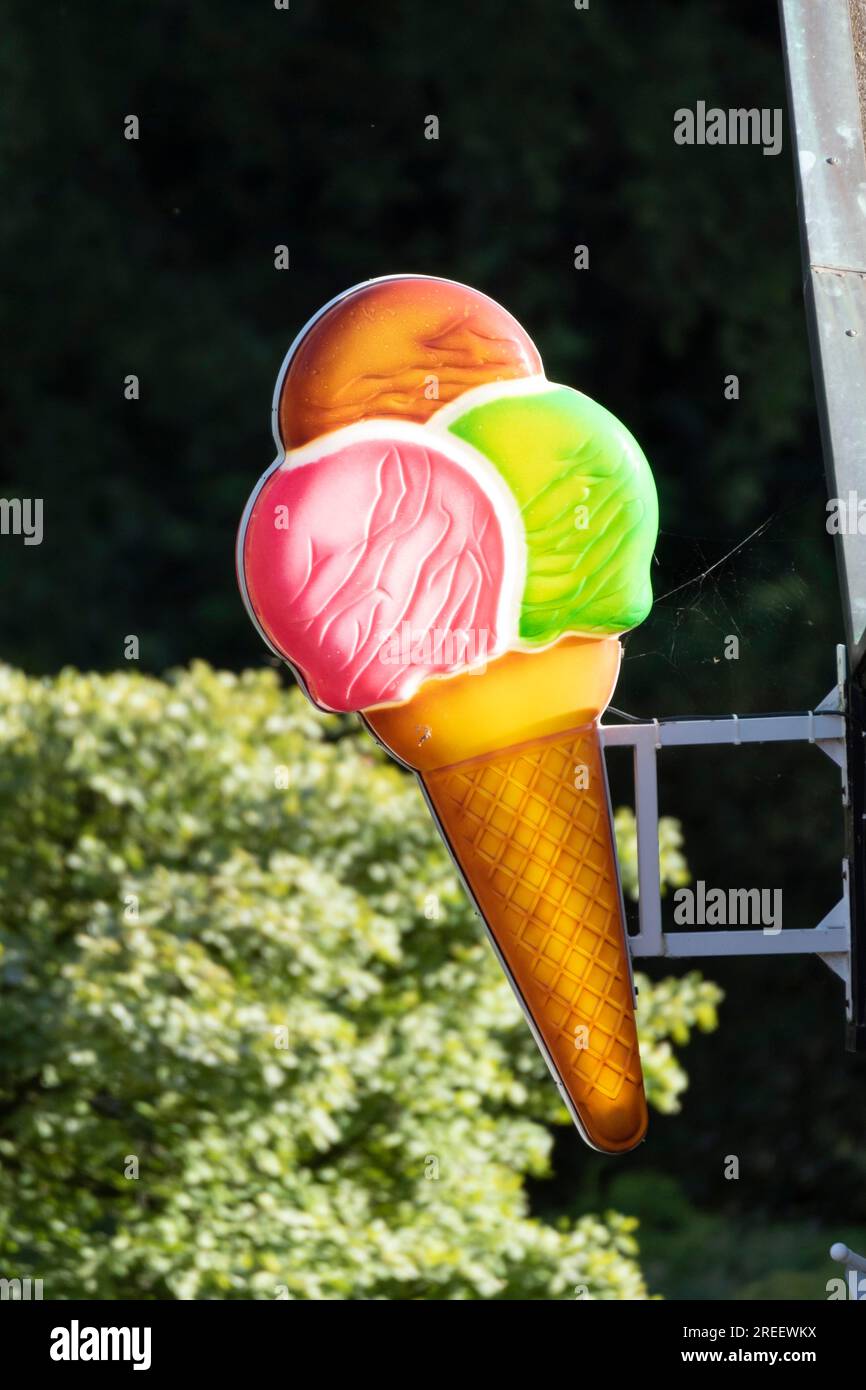 Illuminated sign in the shape of a colourful ice cream cone at an ice