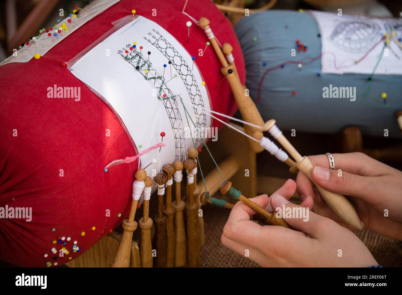 Hands of craftswoman making bobbin lace - folk art Stock Photo