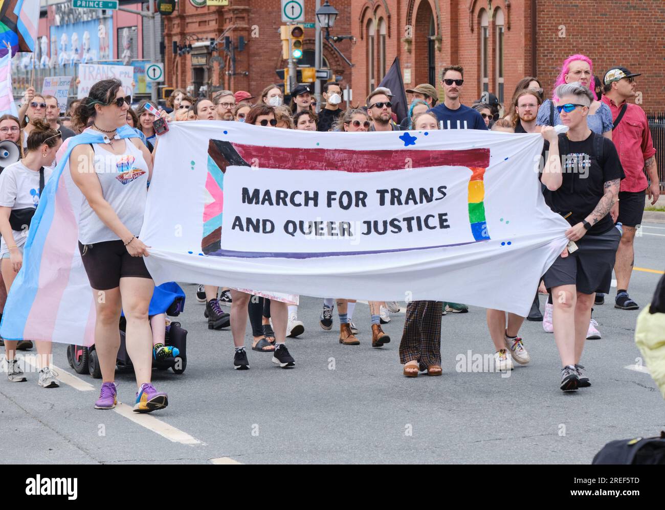 March for trans and Queer Justice of the Streets of Halifax Nova Scotia. Lead banner of crowd Stock Photo