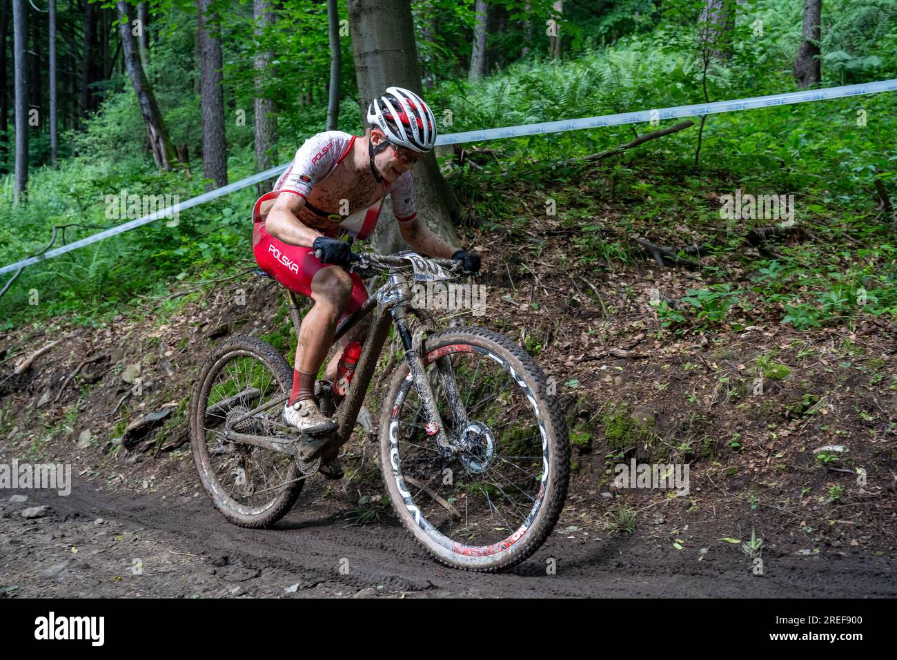 Karol Ostaszewski (Poland) on slippery, muddy uphill - 2023 UEC MTB Elite European Championships - European Games Cracow -Krynica-Zdrój Stock Photo