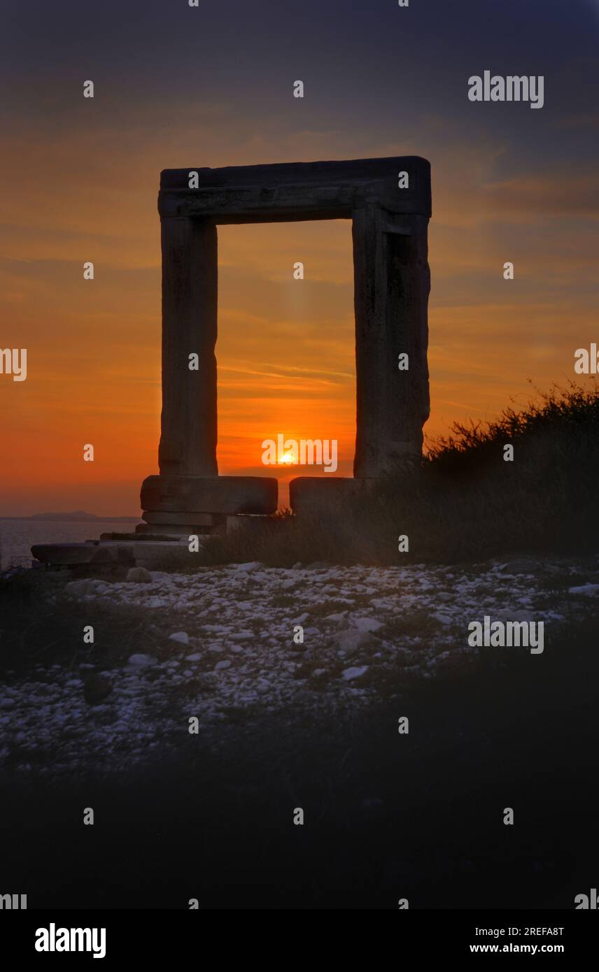 Naxos island, sunset through the Temple of Apollo entrance.  Marble doorway standing alone near the sea at sunset. Stock Photo