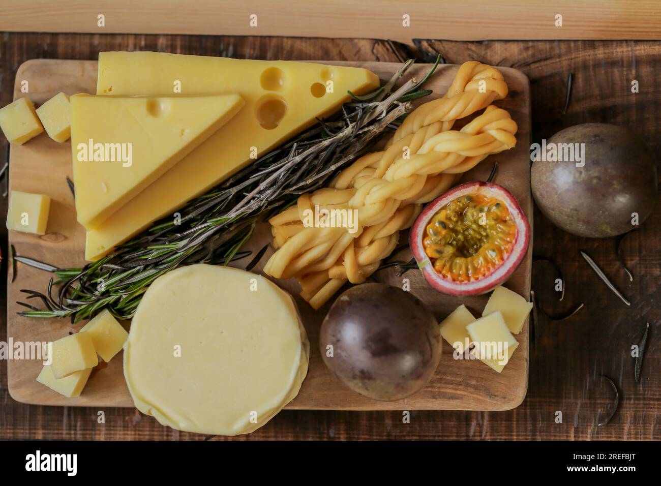 Cheese assorted cut with herbs and fruits.Hard and soft cheeses