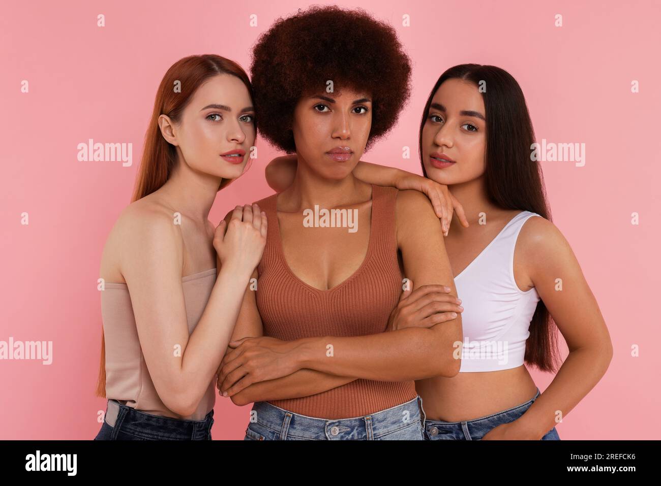 Portrait of beautiful young women on pink background Stock Photo - Alamy