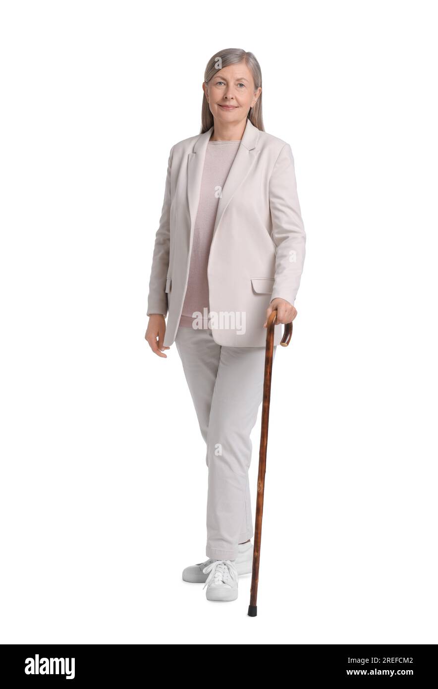 Senior woman with walking cane on white background Stock Photo - Alamy
