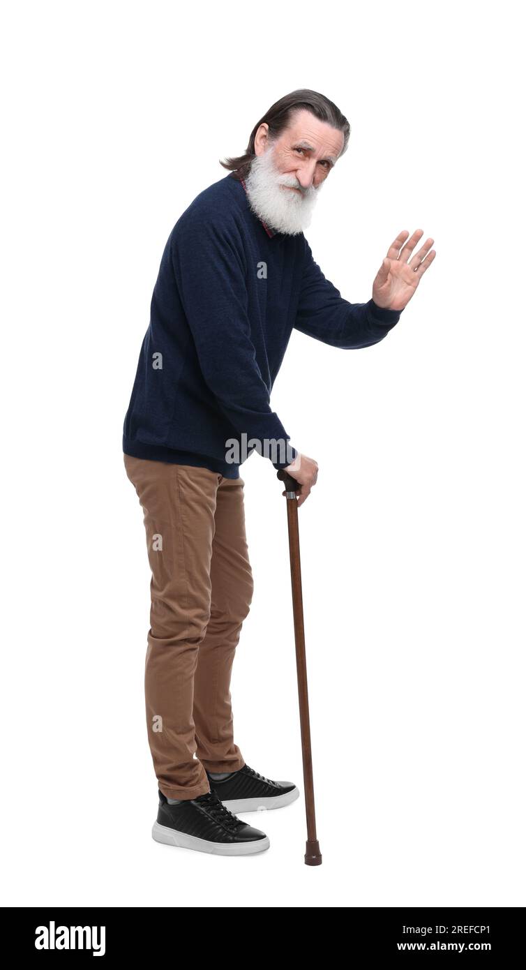 Senior man with walking cane waving on white background Stock Photo - Alamy