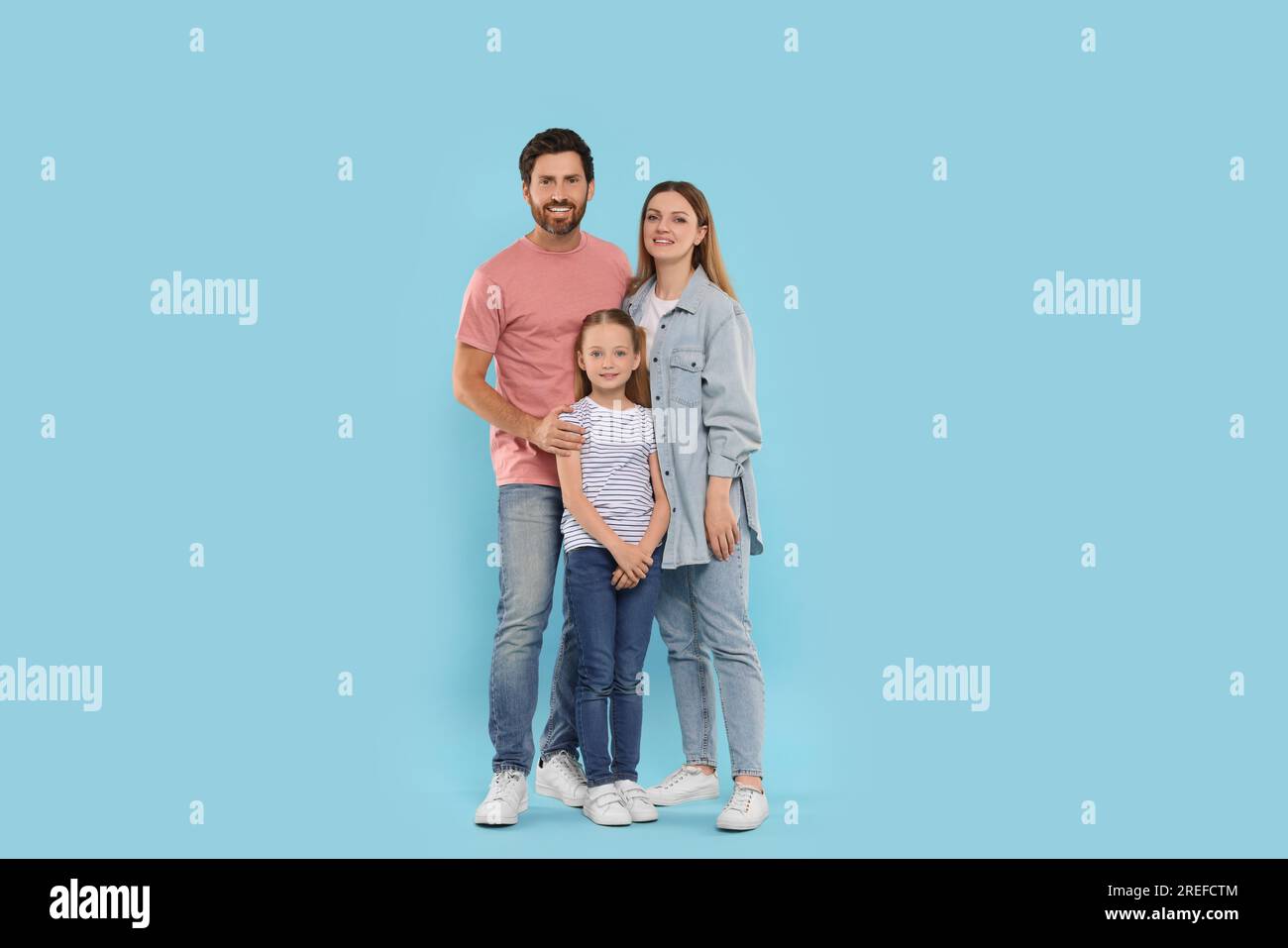 Happy family together on light blue background Stock Photo - Alamy
