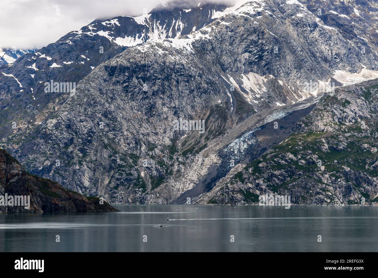 Mountains & Ocean with cloudy sky at Glacier Bay Alaska Stock Photo