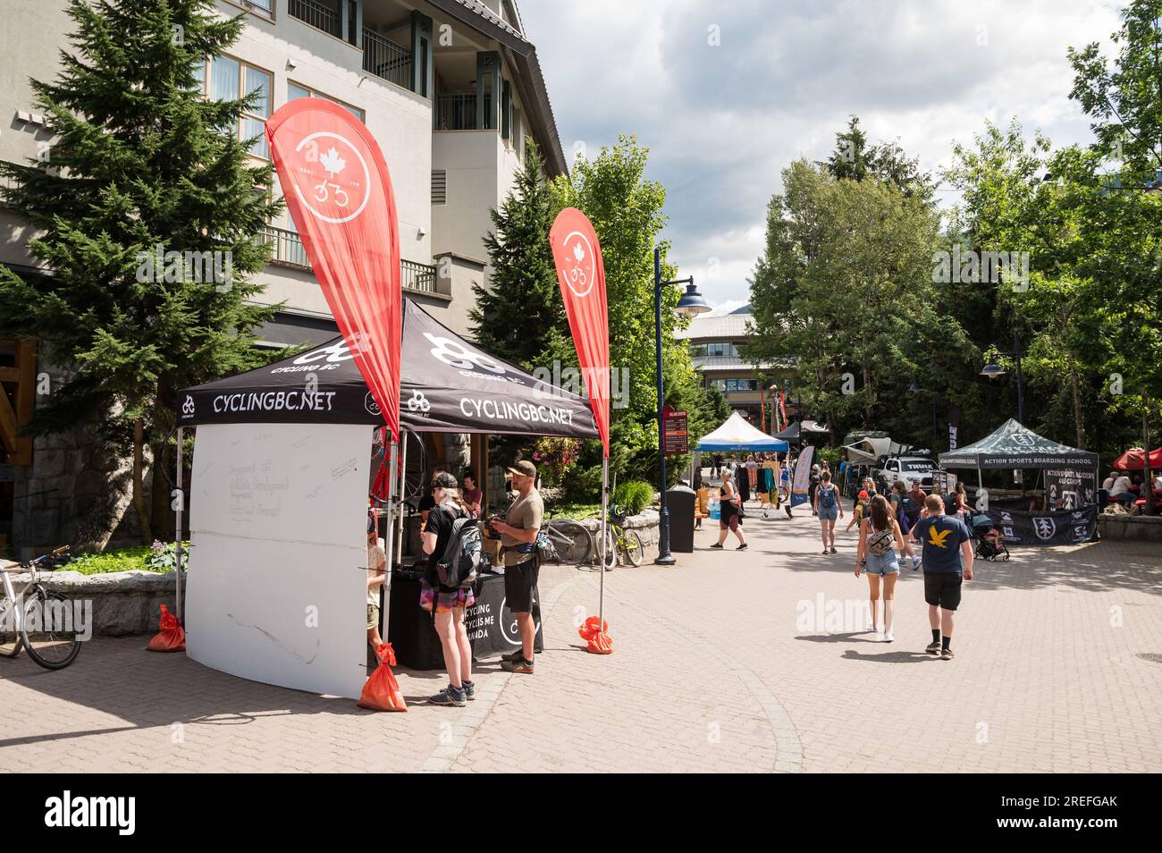Tourists check out trade show booths in the Whistler Village during the annual Crankworx Festival.  Whistler BC, Canada. Stock Photo