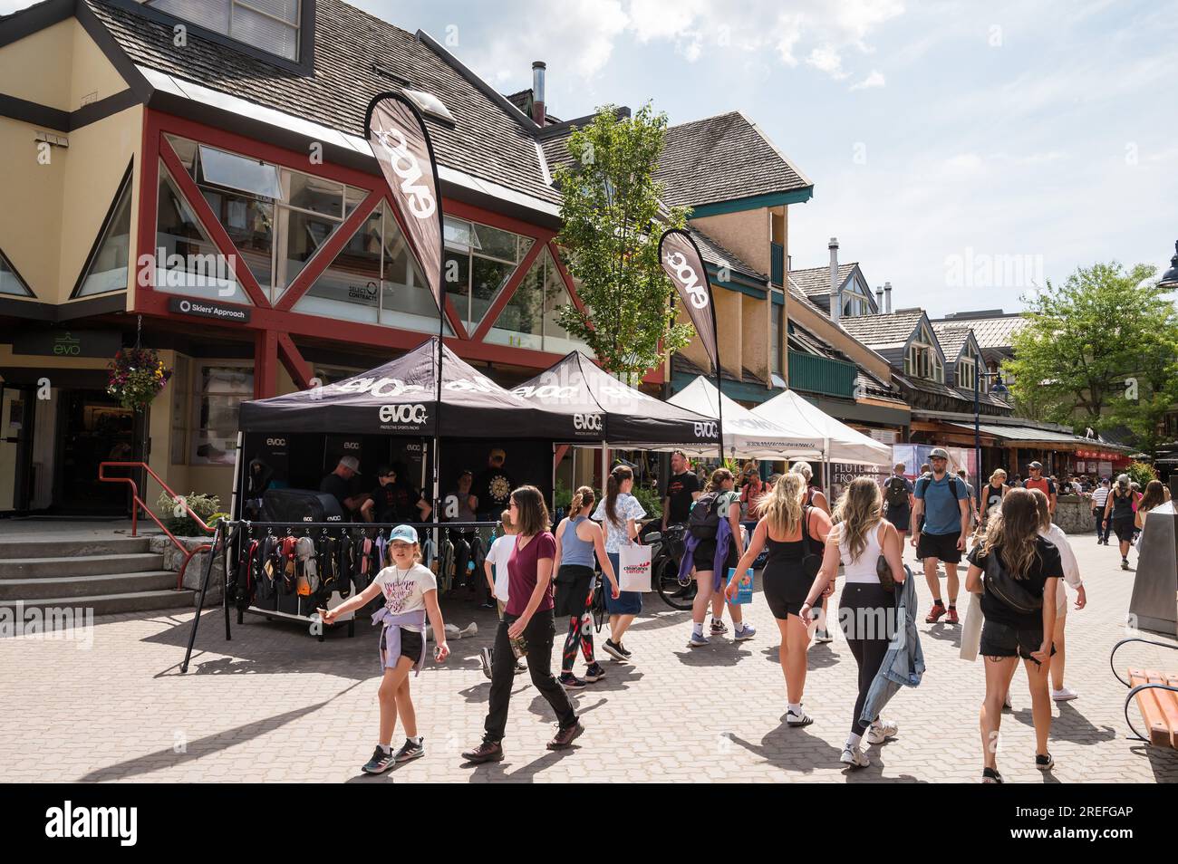 Tourists check out trade show booths in the Whistler Village during the annual Crankworx Festival.  Whistler BC, Canada. Stock Photo
