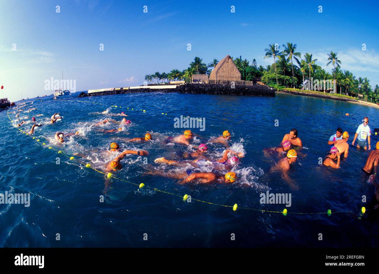 Swimmers at the finish line in the annual Ironman Triatholon at Kailua Kona the Big Island of Hawaii. Ahuena heiau in background. Stock Photo