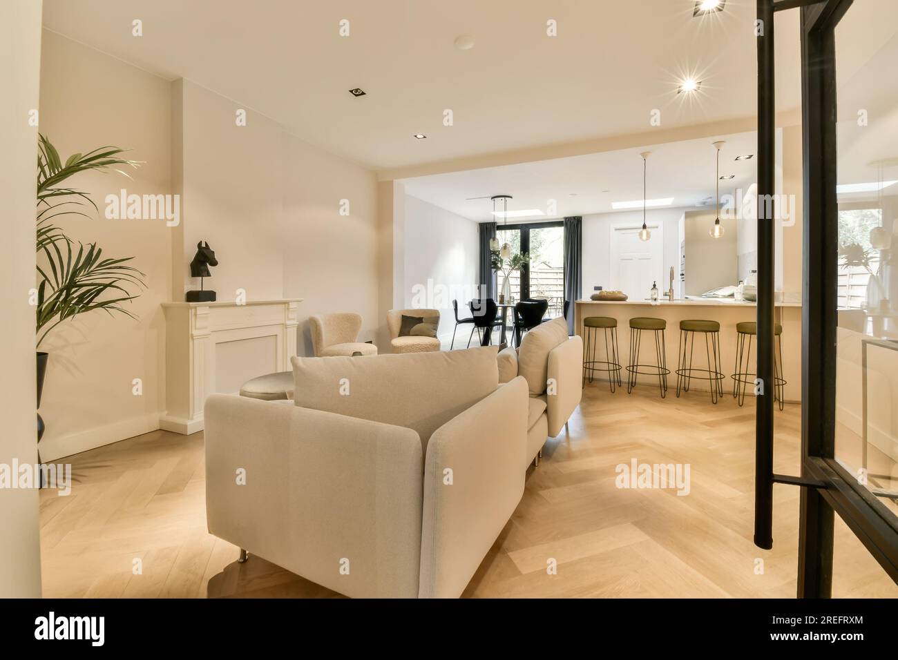a living room with wood flooring and white furniture in the photo is ...