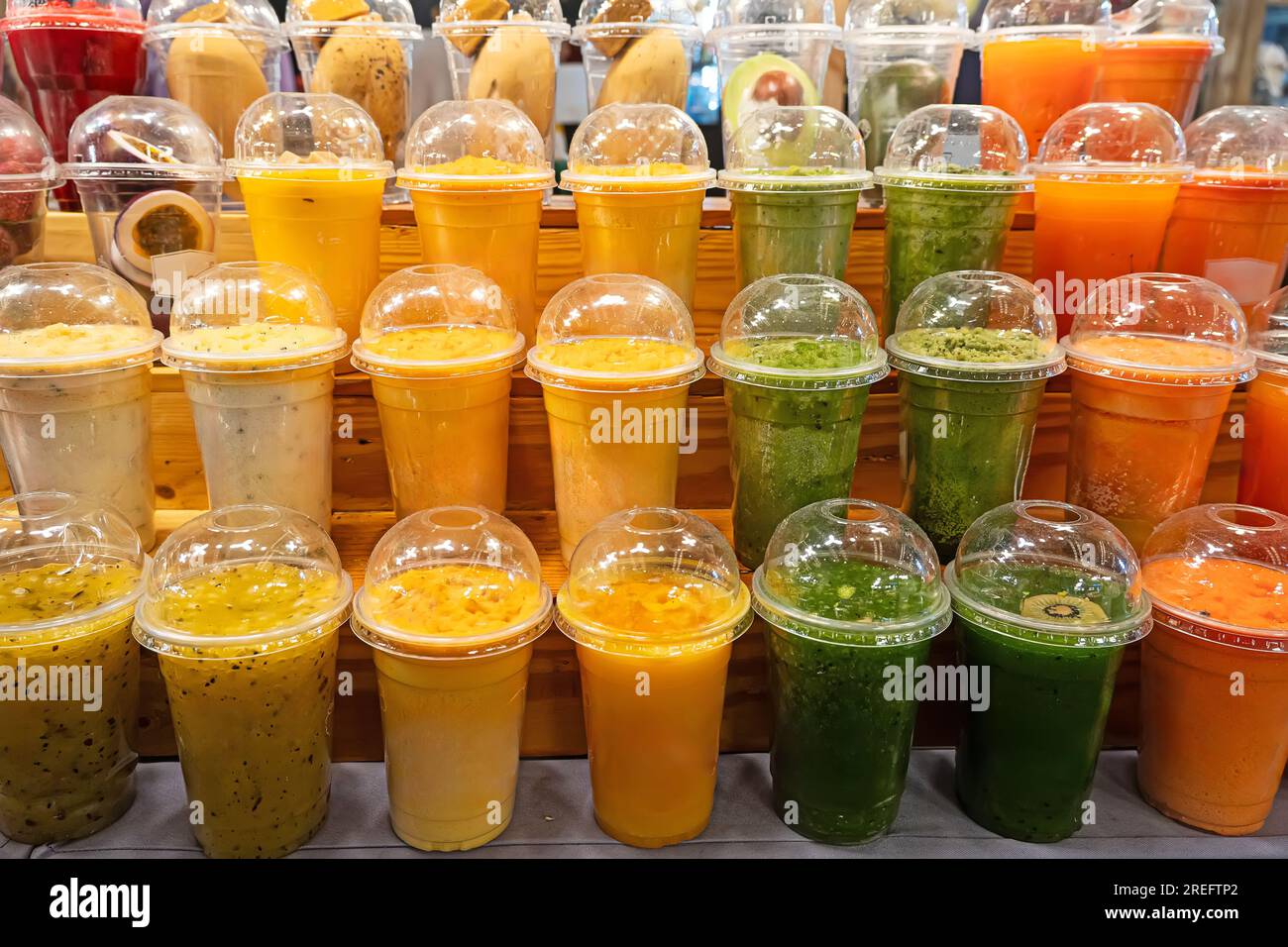 colorful plastic cups with fruit and berry juice at the market, Stock Photo