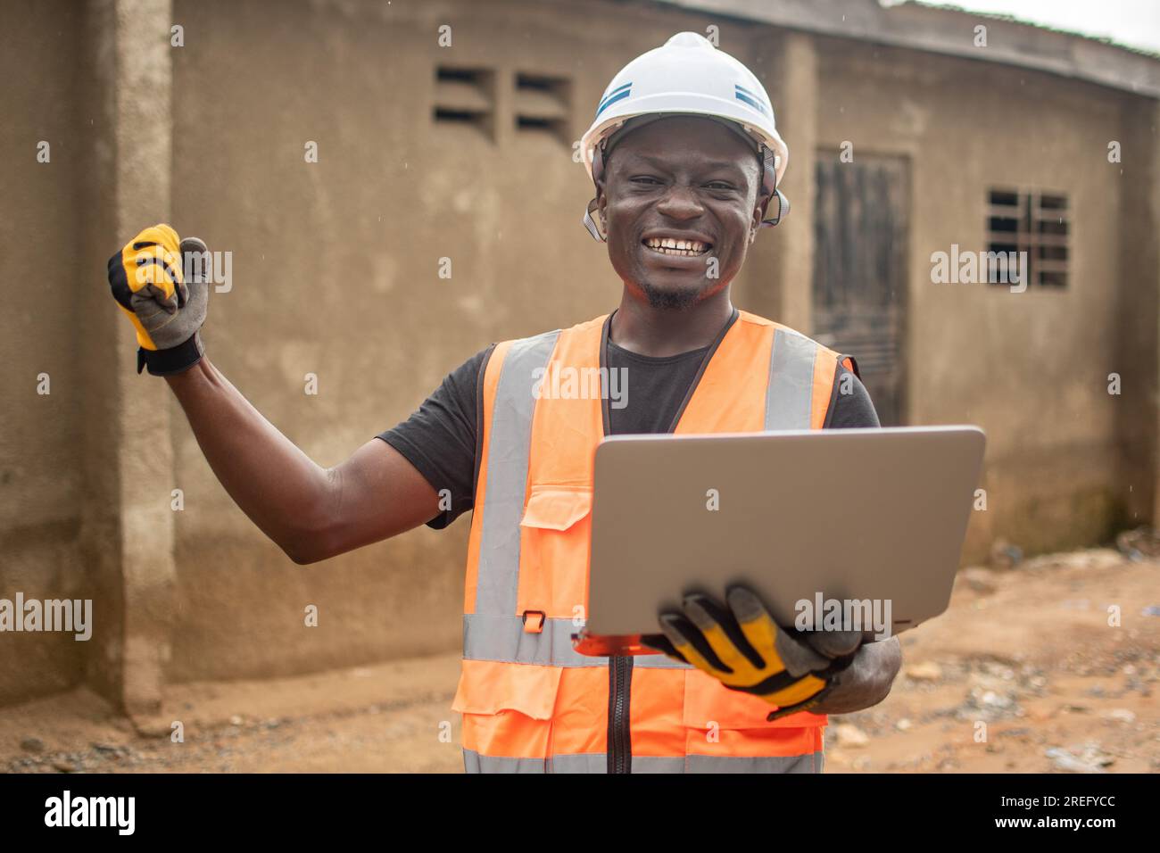 african engineer using his laptop computer rejoices Stock Photo