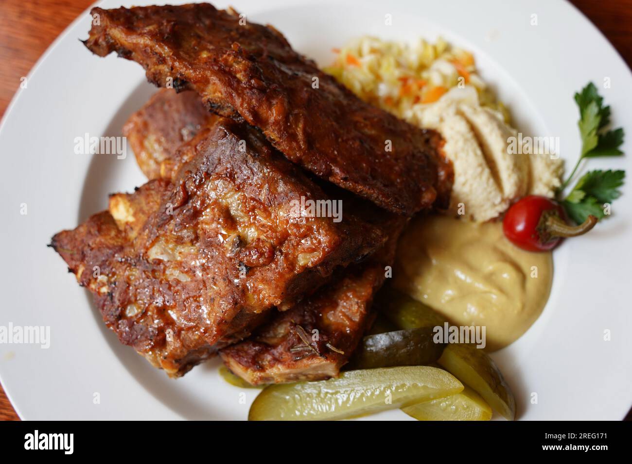 Ribs in spicy marinade with chili, honey, sour cabbage, pickle cucumber ...