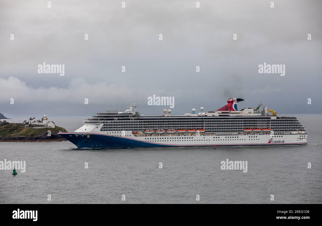 Cork Harbour, Cork, Ireland. 28th July, 2023. On an overcast morning cruise ship Carnival Pride is about to pass the Roches Point lighthouse on her way for a visit to Cobh, Co. Cork, Ireland. - Picture: David Creedon Stock Photo