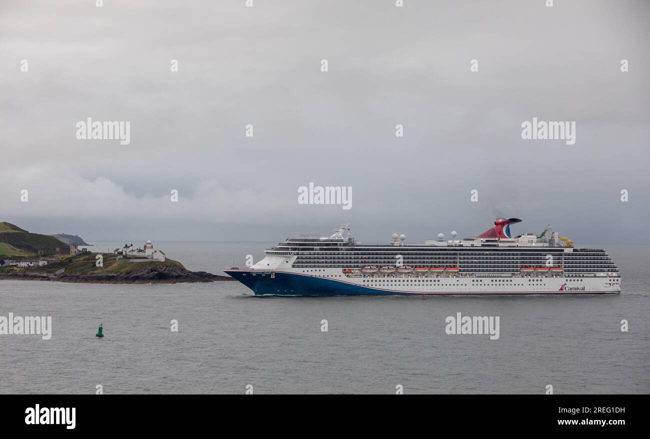 Cork Harbour, Cork, Ireland. 28th July, 2023. On an overcast morning cruise ship Carnival Pride is about to pass the Roches Point lighthouse on her way for a visit to Cobh, Co. Cork, Ireland. - Picture: David Creedon Stock Photo