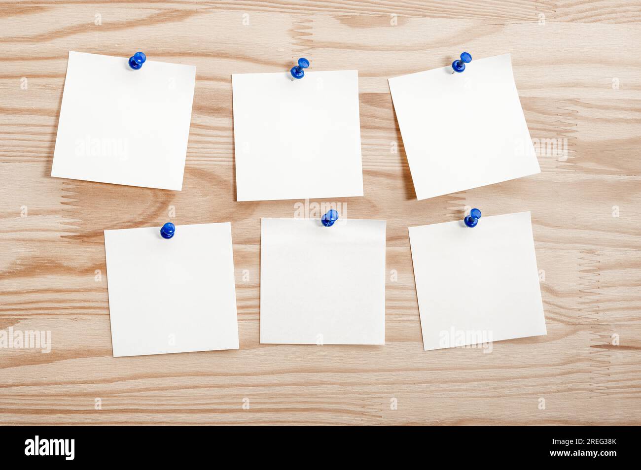 Six white paper notes mockup pinned to wooden bulletin board. sticky