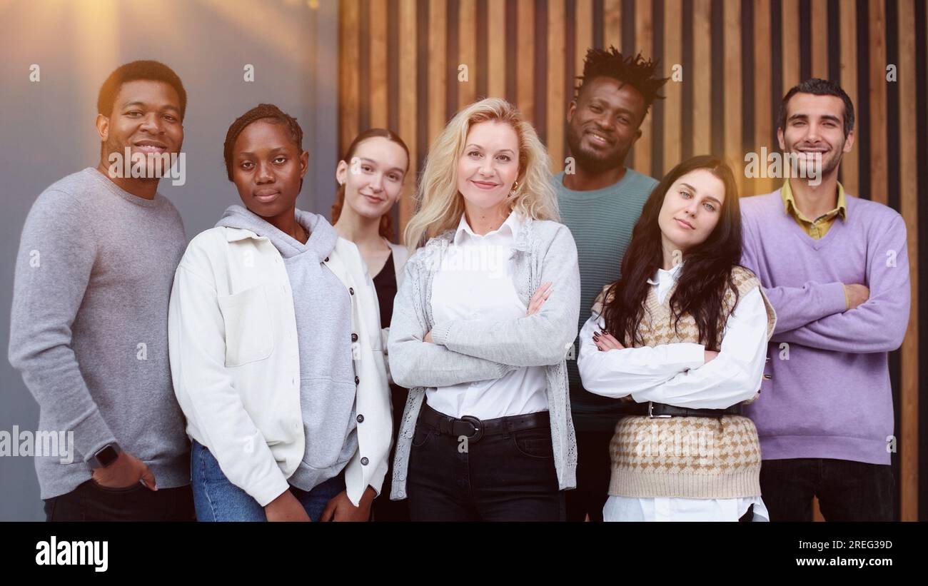 Business team consisting of young business people standing side by side ...