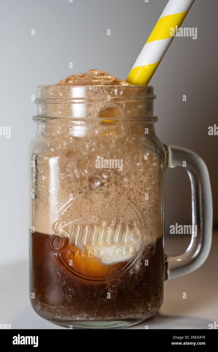 Vanilla Ice cream float served in a frosted glass mug with a yellow