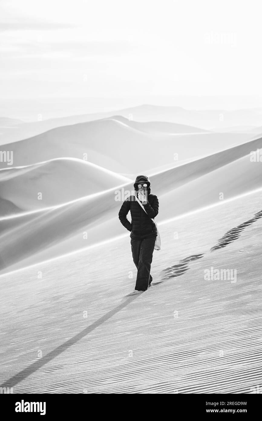 black and white of a lone female hiker in the desert of colorado Stock Photo