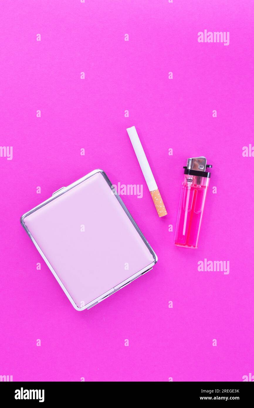 Cigarette, case and lighter against pink Stock Photo