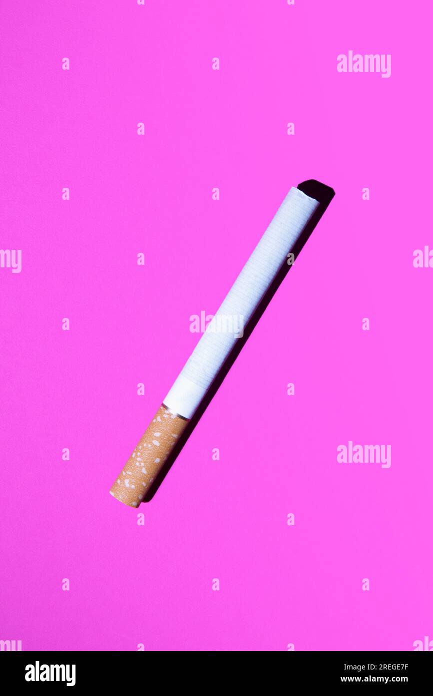 Top view on cigarette against pink Stock Photo