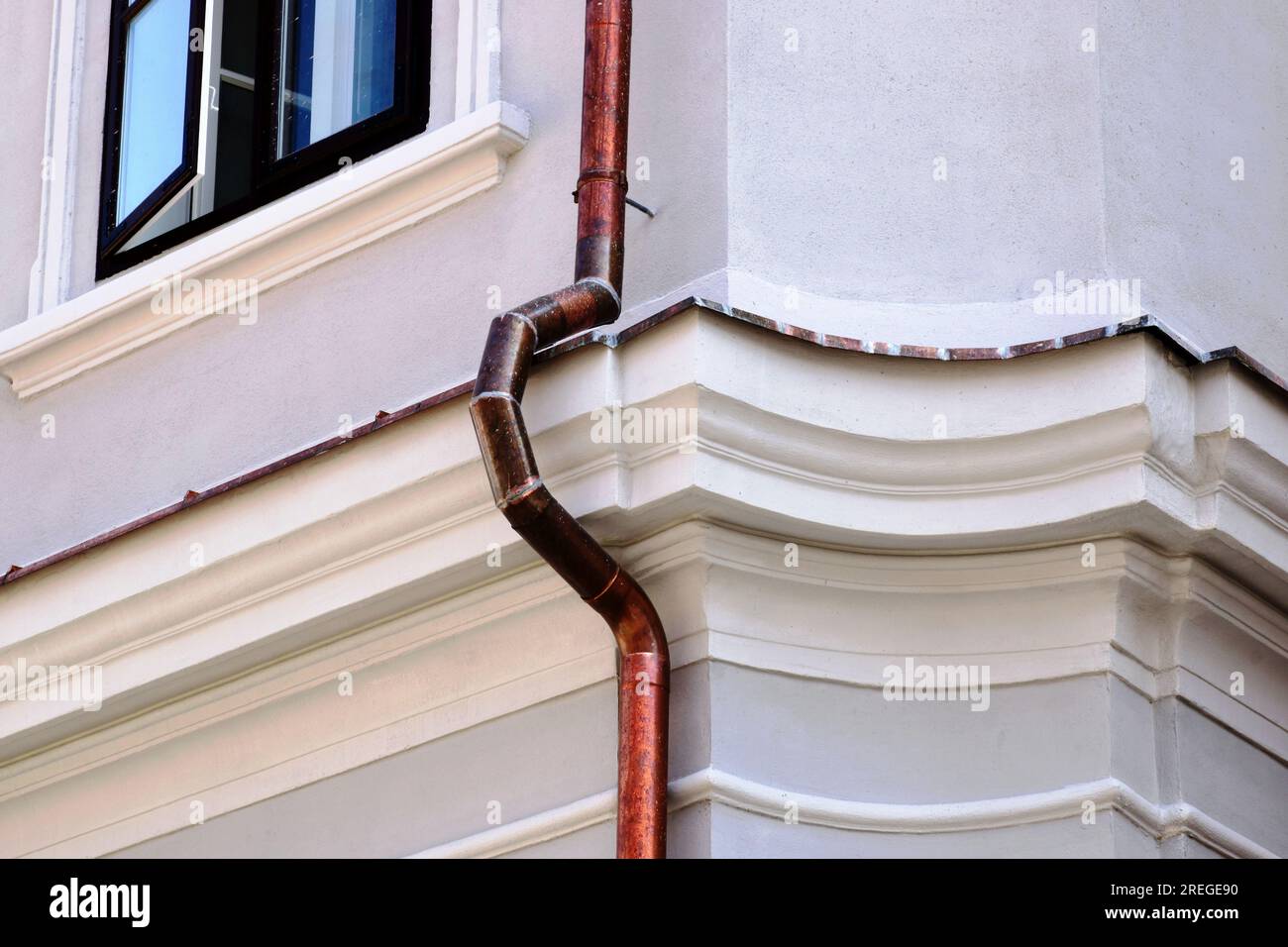 shiny new copper rain water leader downspout. down pipe detail. home