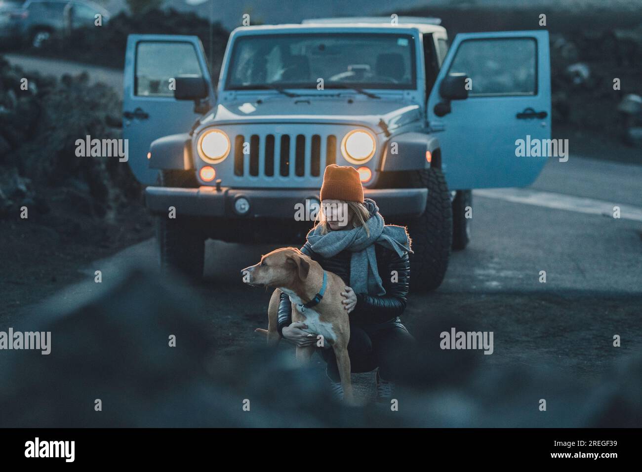 woman lets her pitbull mix out of car for a pee break on road trip
