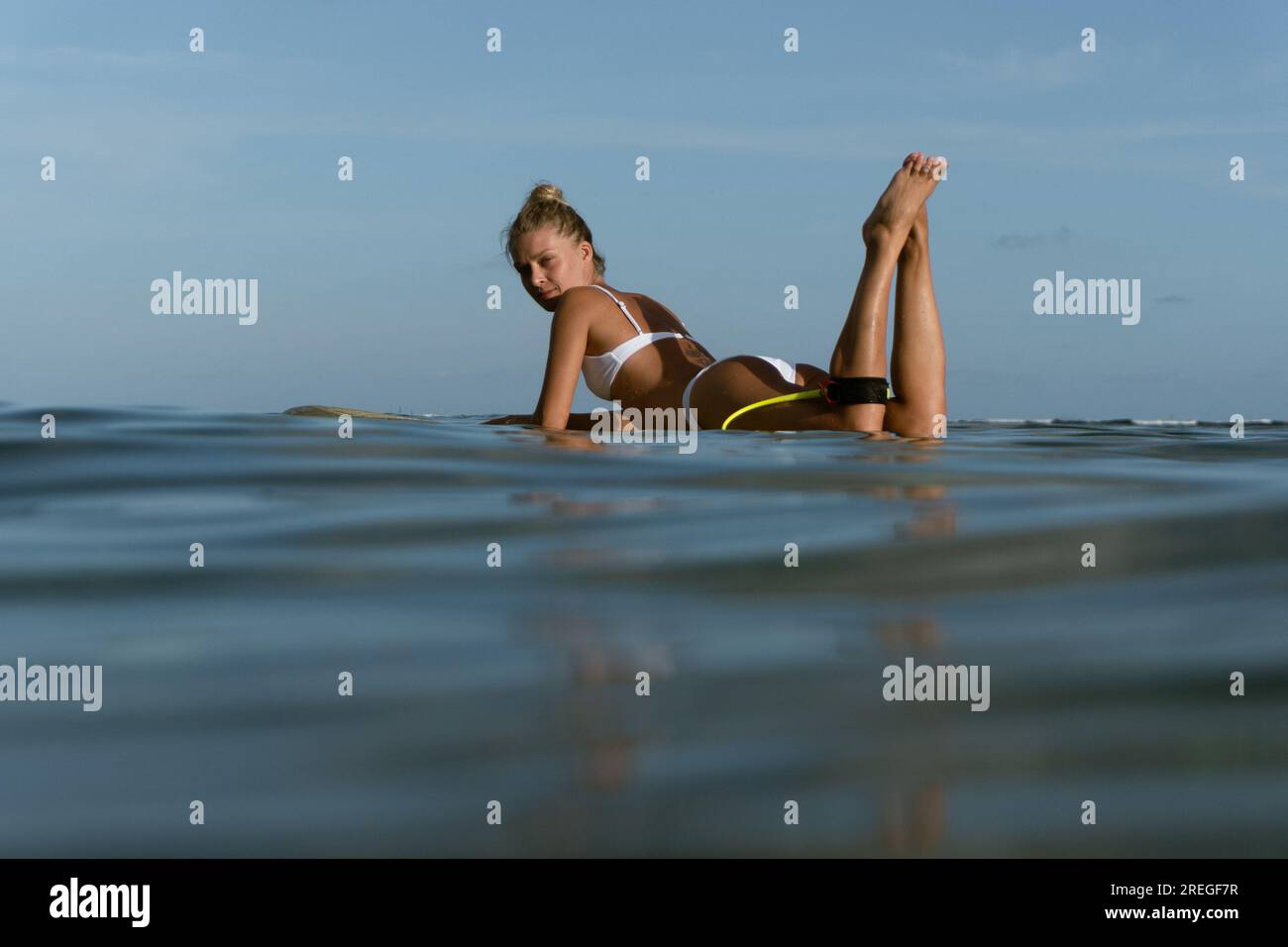 Surfer woman on a wave. Happy woman lying on surfboard Stock Photo