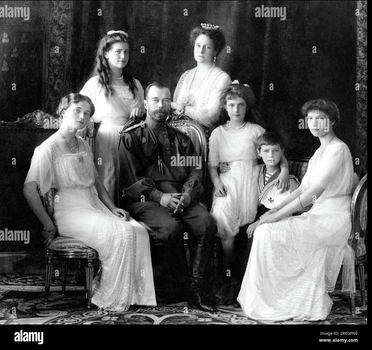The Romanovs - seated (left to right) Marie, Queen Alexandra, Czar Nicholas II, Anastasia, Alexei (front), and standing Olga and Tatiana - 1914 Stock Photo