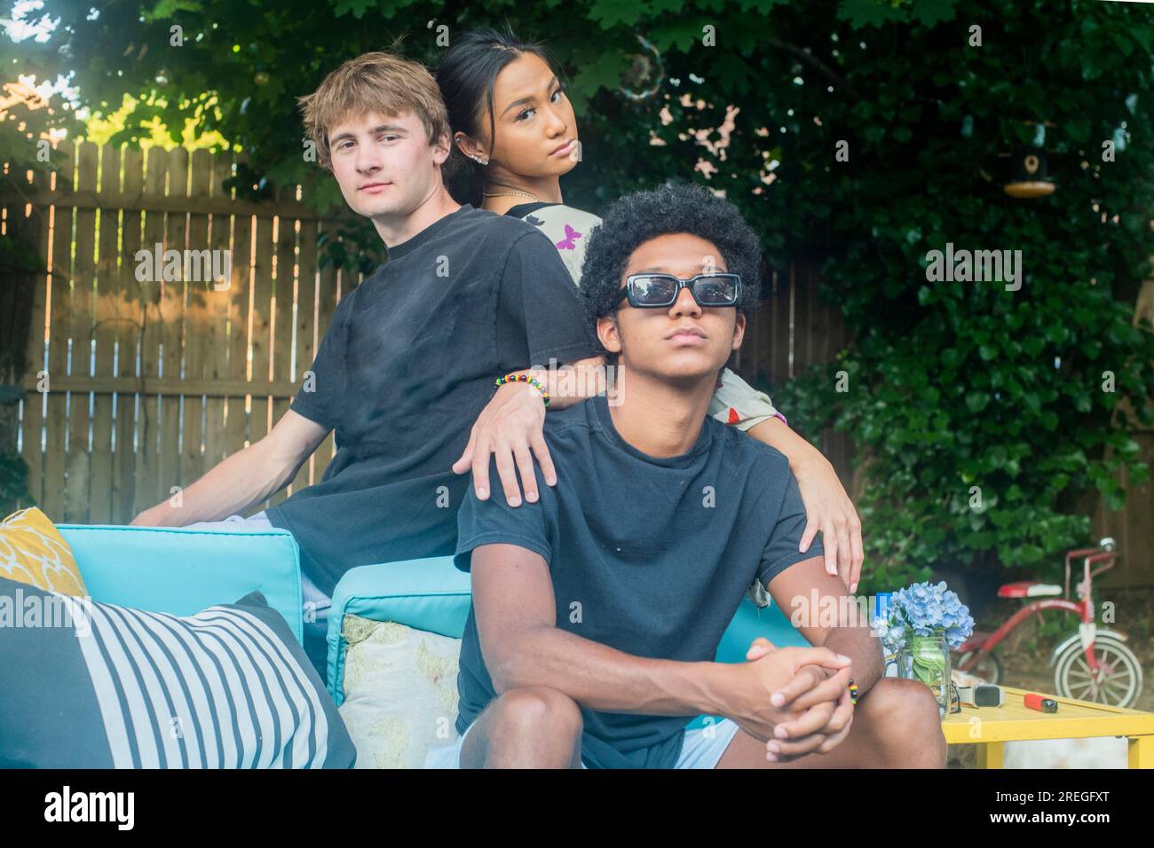 Mod Squad of teens hang out in backyard Stock Photo