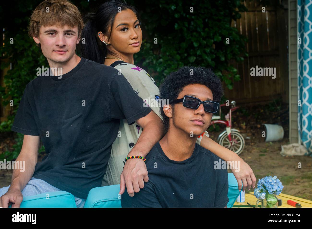 Mod Squad of teens hang out in backyard Stock Photo