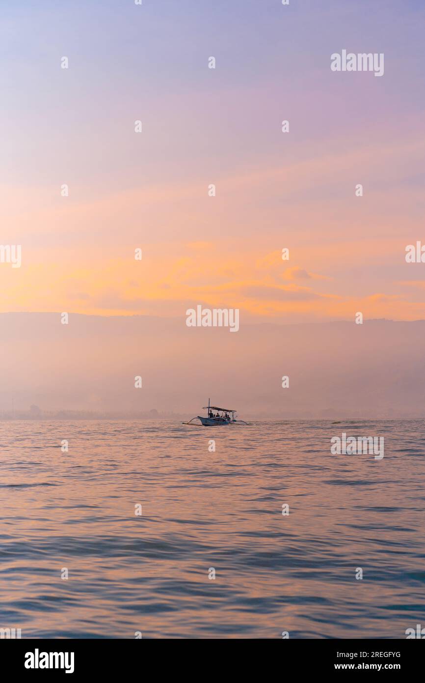 Tourists looking for dolphins at Lovina in Bali. Morning boat trips. Stock Photo