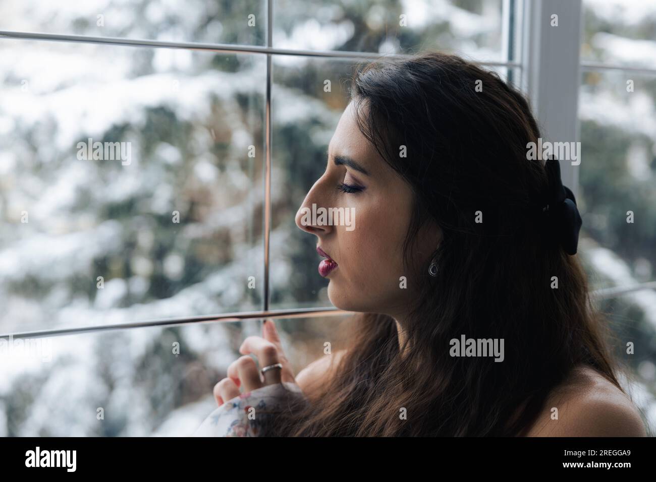 Girl posing near a large beautiful window Stock Photo