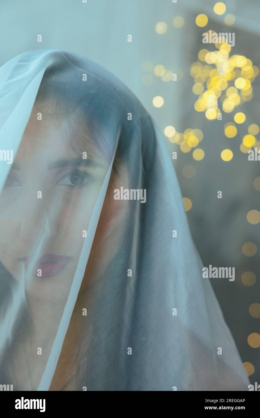 Close-up of a girl under a veil against the background of lanterns Stock Photo