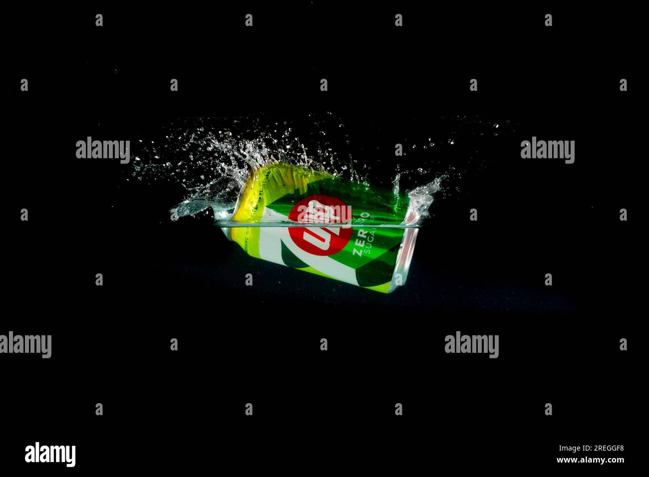 London, United Kingdom, 24th July 2023: A Can of 7Up splashing into water against a black background Stock Photo