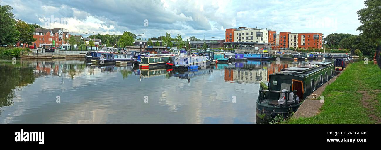 Wide panoramic view of Northwich Marina with moored narrowboats and waterside development, Northwich, Cheshire, England, UK CW9 5HD Stock Photo