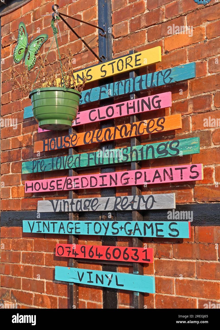 Colourful hand-painted sign outside Leon’s Store on Tabley Street in Northwich, Cheshire, advertising second-hand and vintage goods, CW9 5DP Stock Photo