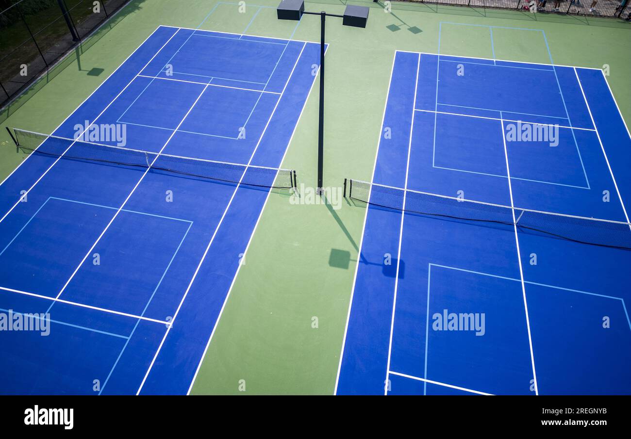 Drone view of two tennis courts that also have pickleball lines and