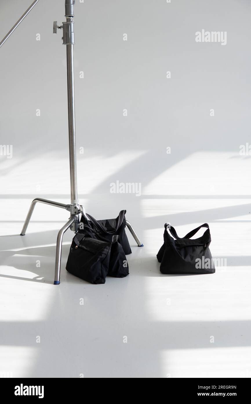 Three sand bags on a studio cyclorama with a stand, cstand