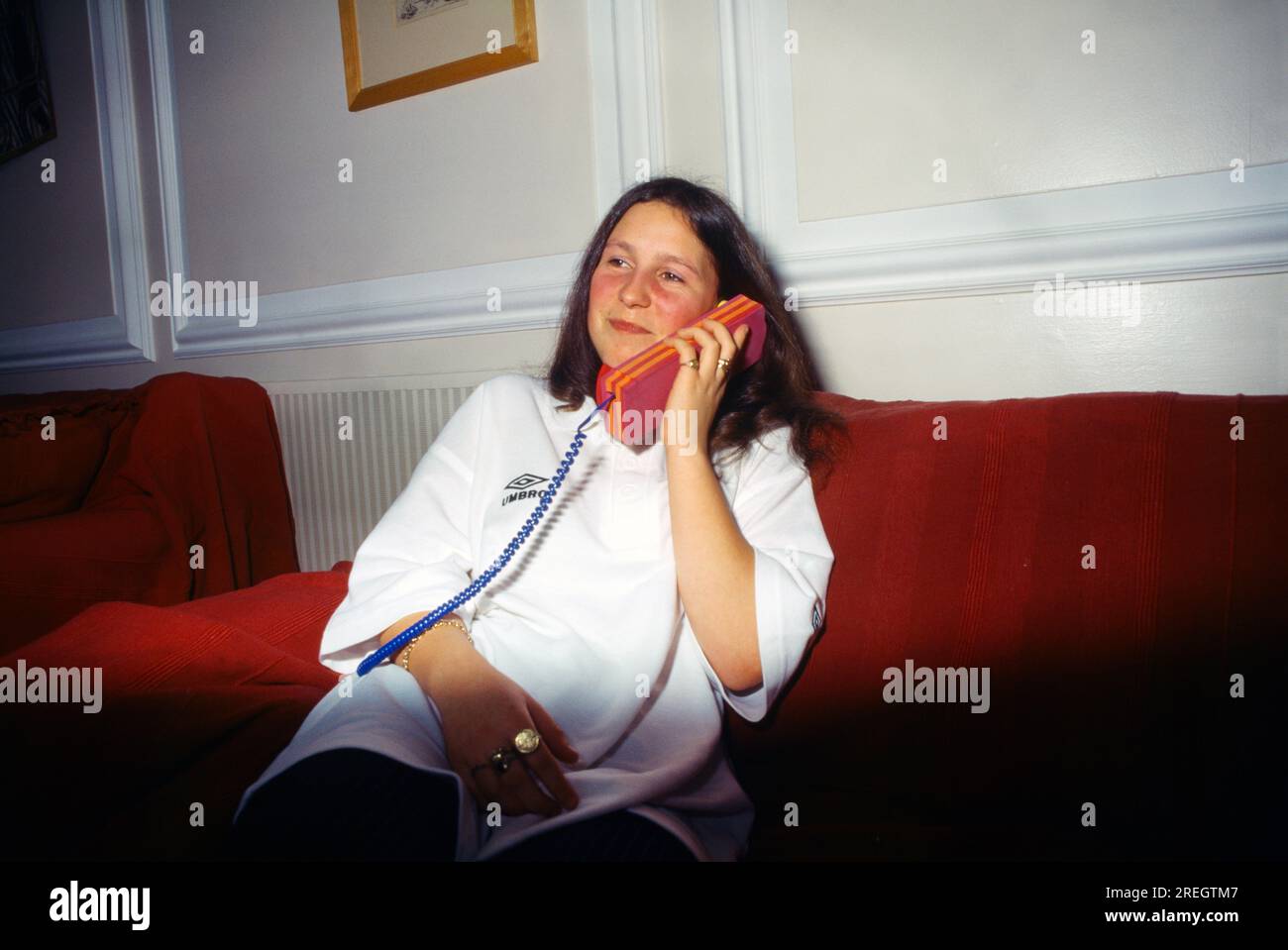 Teenager Talking on Novelty Foam Telephone Surrey England Stock Photo