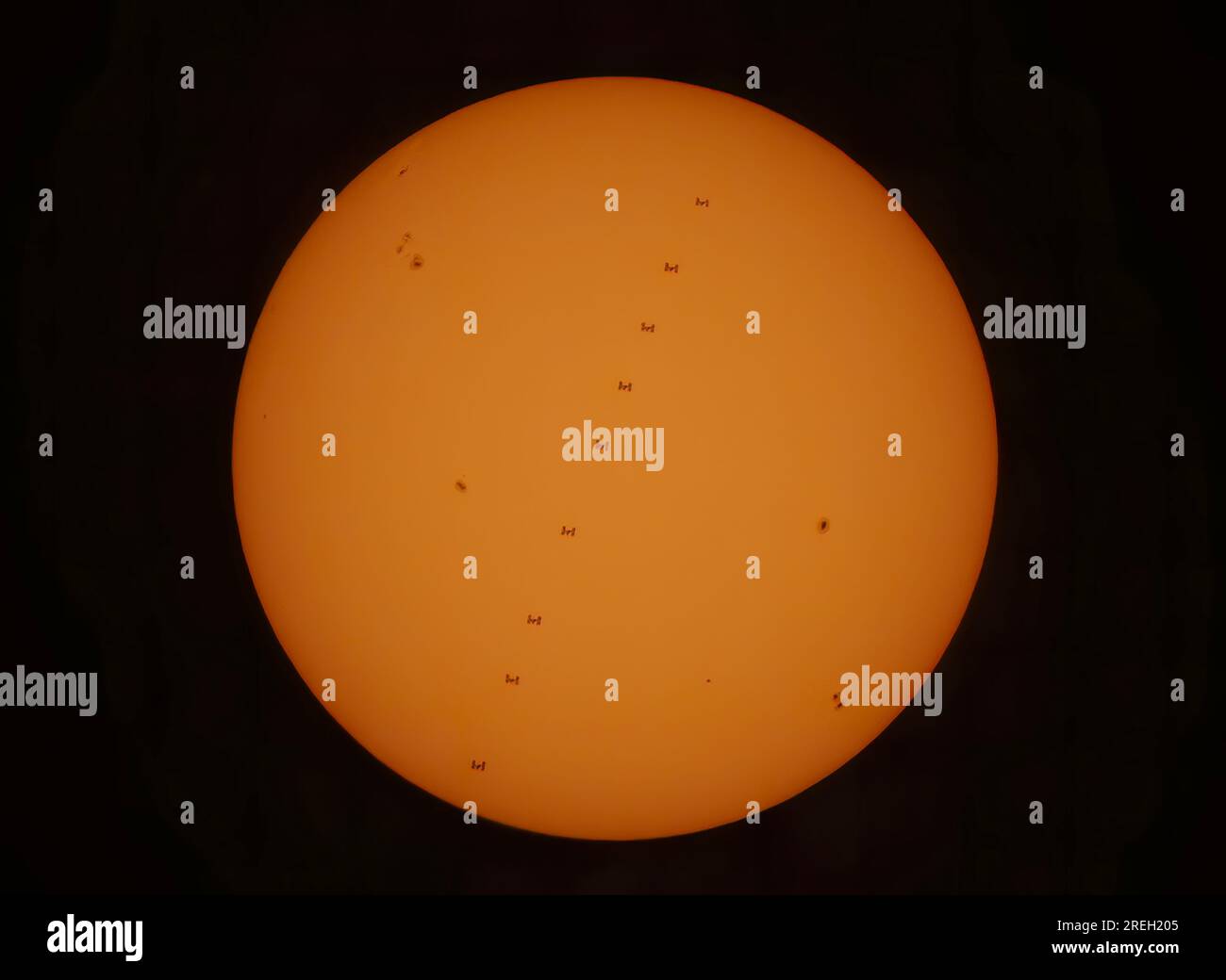 International Space Station (ISS) transiting across the face of the sun, a composite of several photos Arnprior, Canada July 27, 2023 Stock Photo
