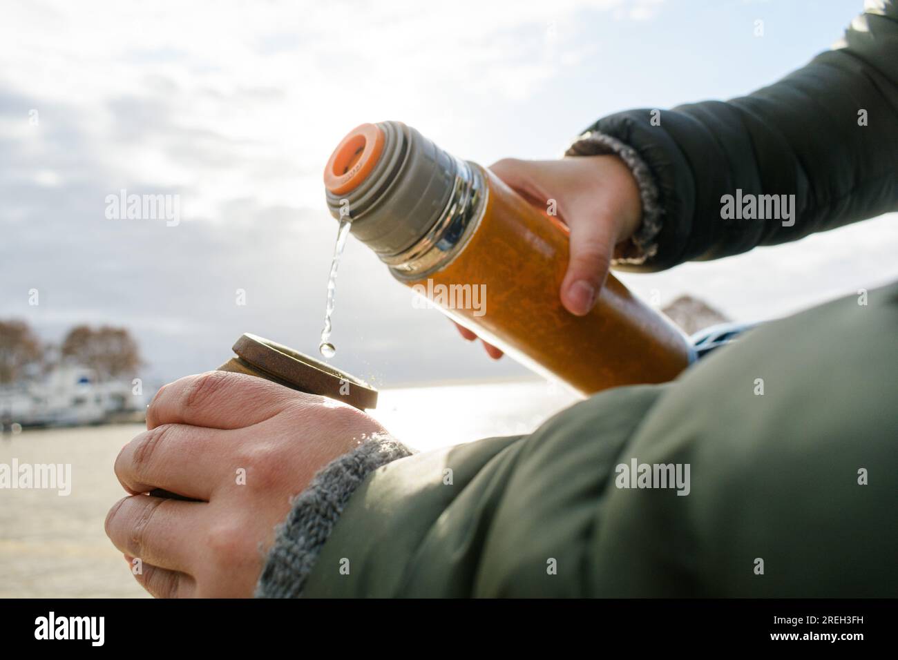 https://c8.alamy.com/comp/2REH3FH/closeup-of-female-caucasian-hands-preparing-mate-outdoors-at-sunrise-with-sky-in-background-and-copy-space-2REH3FH.jpg